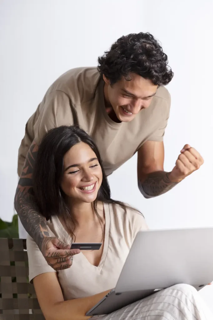HVAC Financing Palm Coast - Happy couple looking down at laptop.